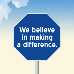 A blue octagon with the words We believe in making a difference printed in the middle sits on a light blue and yellow background with white clouds in the upper left corner.