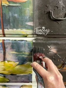 Close up of painted drawers that have Lily Pads decoupage paper with a hand holding a paint brush over the seam of the paper