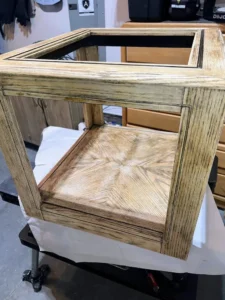 Wooden end table with all of the black paint stripped off