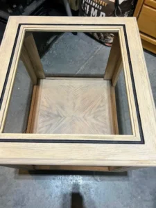 A VooDoo Gel Stained end table with Caviar Chalk Mineral Paint painted into the ridge of the table